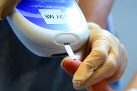 A nurse giving a patient a diabetes test