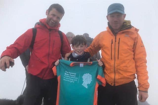 A triumphant Benji (middle) on Mount Snowdon. Image: The Cox family.