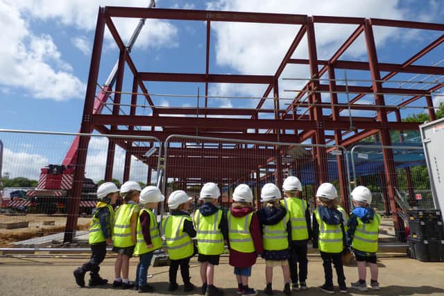 Pupils at the school keeping an eye on construction as the block was built