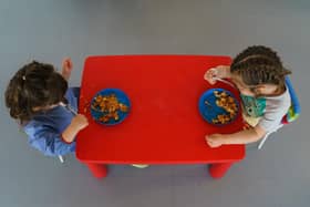 File photo of children eating at a pre-school (Photo by CESAR MANSO/AFP via Getty Images)