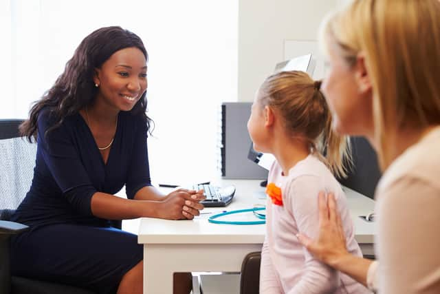 Woman and child visiting doctor in surgery