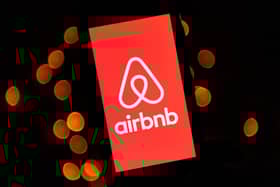 Logo of the online lodging service Airbnb displayed on a smartphone in Paris. Photo by LIONEL BONAVENTURE/AFP via Getty Images