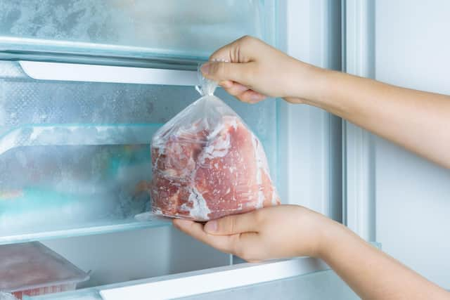 Taking frozen meat from the modern no-frost freezer