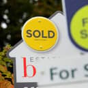 File photo of a sold and for sale signs.