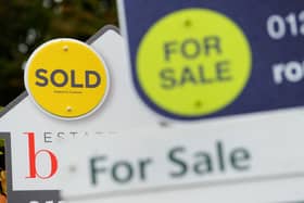 File photo of a sold and for sale signs.