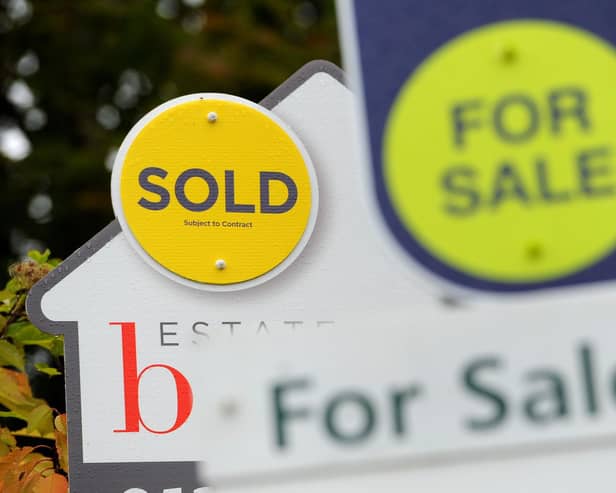 File photo of a sold and for sale signs.