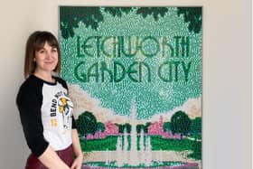 Potton artist Katie Hounsome pictured with the Lego art of her poster