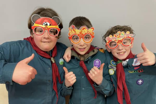 Gamlingay Scouts celebrate the Chinese New Year (L-R: Amy, Ben and Benji)