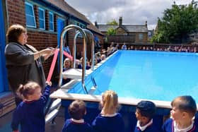 The Mayor cuts the ribbon to officially reopen the pool.