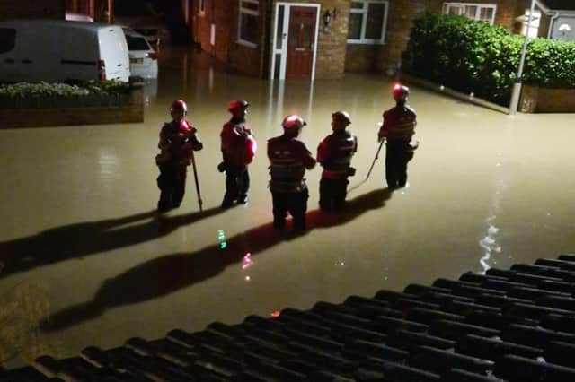 Emergency workers standing in flood water during the recent Central Bedfordshire floods. Picture: Debbie Ward