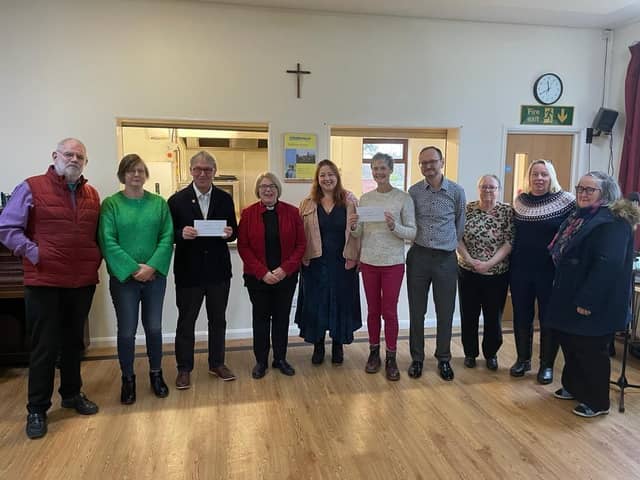 St Andrew's Church Reverend Liz Oglesby-Elong with representatives from Tibbs Dementia and Save The Children .