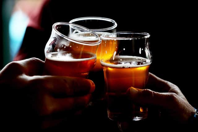 Customers clink their glasses while drinking  (Photo by Justin Sullivan/Getty Images)