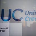 A Universal Credit sign on a door of a job centre plus