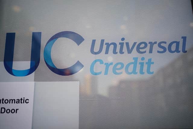 A Universal Credit sign on a door of a job centre plus