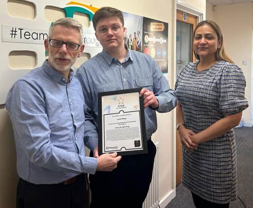 Lewis Mayo receives his Stagecoach Star of the Month Award from Darren Roe (left) and Hema Russell (right)
