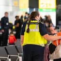 File photo: A member of Border Force staff assists a female evacuee as refugees arrive from Afghanistan at Heathrow Airport. (Photo by Dominic Lipinski  - WPA Pool/Getty Images)