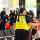 File photo: A member of Border Force staff assists a female evacuee as refugees arrive from Afghanistan at Heathrow Airport. (Photo by Dominic Lipinski  - WPA Pool/Getty Images)