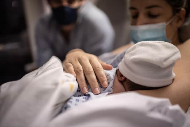 File image of baby and parents on a maternity ward (Photo by MARTIN BUREAU/AFP via Getty Images)