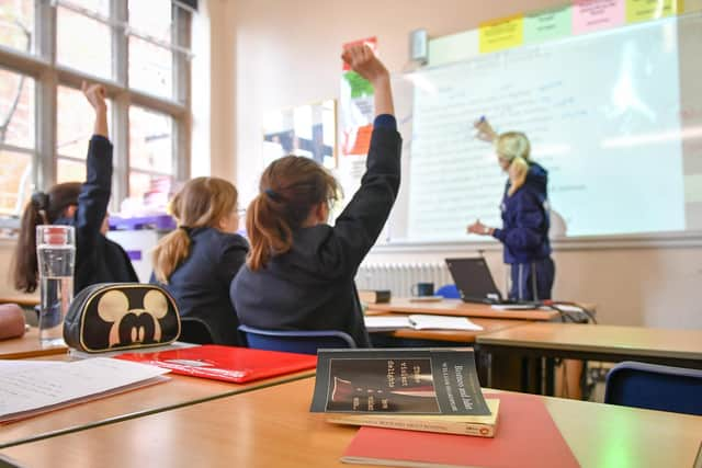 File photo of a teacher and students in a classroom.