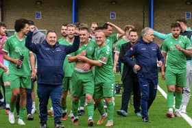 Biggleswade FC celebrate their FA Cup win over Canvey Island, with joint-bosses Dave Northfield (front) and Mark Inskip (third from right). Photo: Guy Wills Photography.