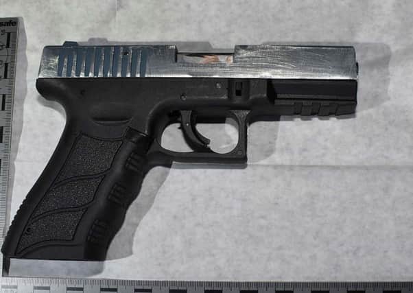 Police found this gun, ammunition and Class A drugs believed to be heroin in the early morning raid.