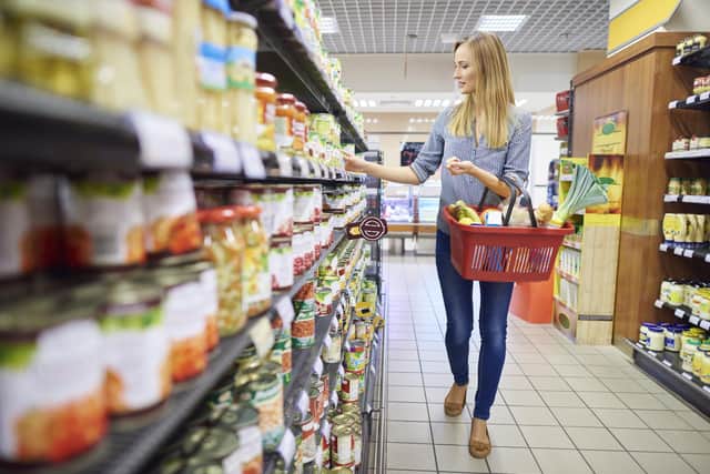 Woman buying products in food aisle