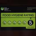 A Food Standards Agency rating sticker on a window of a restaurant.