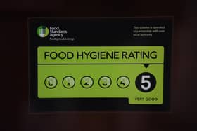 A Food Standards Agency rating sticker on a window of a restaurant.