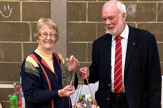 Janice receiving an engraved vase from Derek Batchelor, Chairman of the Bedfordshire Badminton Association.