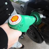 A person fills up at a Shell petrol station