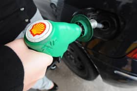 A person fills up at a Shell petrol station