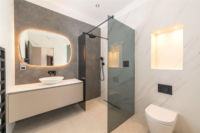 All the bathrooms and cloakrooms have Inalco large format porcelain tiles, downlights, niche lights and heated, backlit mirrors.