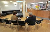 Undated file photo of patients sitting in the waiting room at a GP practice.
