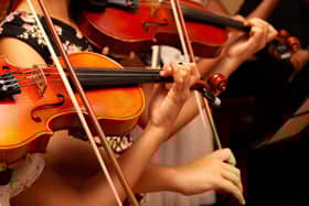 A performance from a children's orchestra string section. Image: Adobe Stock.