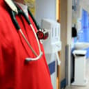 File photo of a person in scrubs at a hospital.