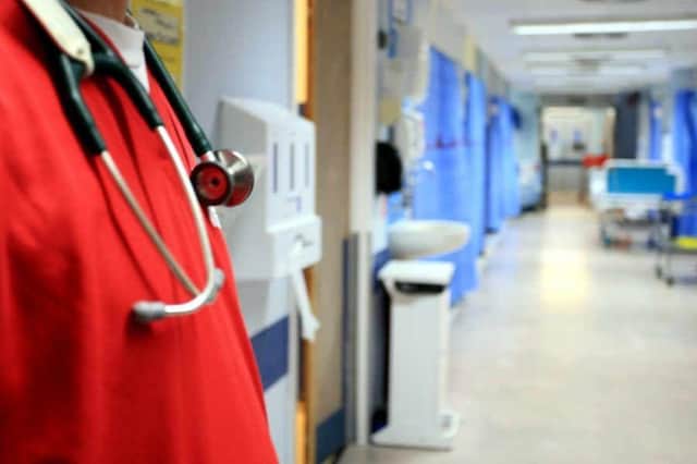 File photo of a person in scrubs at a hospital.