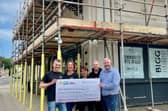 Smiles all round as the team proudly display a donation for the Bigg Theatre from Asda