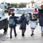 Parents walk their children to school Nick Ansell/PA Wire