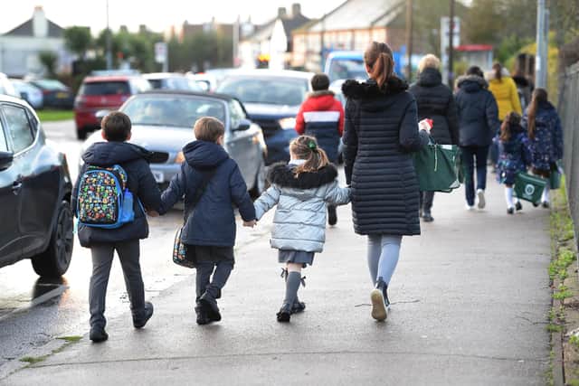 Parents walk their children to school Nick Ansell/PA Wire