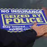 A sticker is placed on the windscreen of an uninsured car after it is seized by police