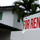 A "for rent" sign is posted in front of a home (Photo by Joe Raedle/Getty Images)