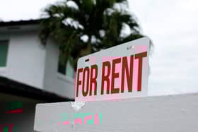 A "for rent" sign is posted in front of a home (Photo by Joe Raedle/Getty Images)