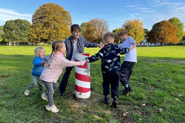 Children dance around the felled Maypole (Picture: Mike Wells)