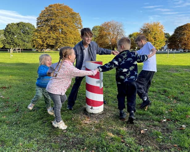 Children dance around the felled Maypole (Picture: Mike Wells)