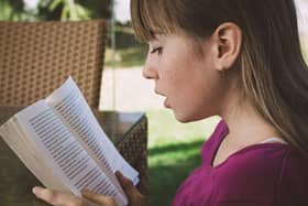 A girl reading a book outside. PIC: Petra from Pixabay