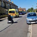Image shows a mobility scooter user forced on to the road by a car parked on the pavement