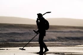 A metal detectorist on Bournemouth Beach, Dorset. Picture: Adam Davy/PA
