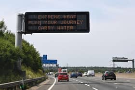 A road sign reads "Extreme Heat, Plan your journey, Carry water", warning motorists about the heatwave forecast for July 18 and 19 (Photo by Damien MEYER / AFP)