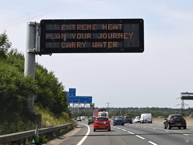 A road sign reads "Extreme Heat, Plan your journey, Carry water", warning motorists about the heatwave forecast for July 18 and 19 (Photo by Damien MEYER / AFP)