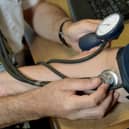 A doctor checking a patient's blood pressure